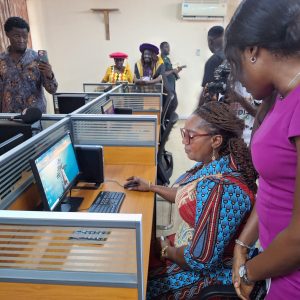 Eastern Regional Minister, Hon. Rita Akosua Adjei Awatey, exploring one of the newly installed computers in the Digital Education lab at PWCE, 