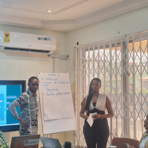 One of the female school leaders presenting findings from her group's breakout discussion during the afiDE Ghana International Women's Day dialogue